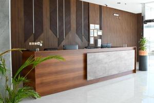 an office lobby with a reception desk with a sign at Corp Yanbu Hotel - B2 in Yanbu