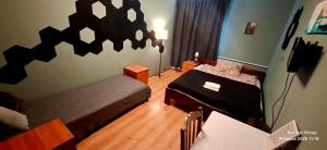 a bedroom with two beds and a table and a dining room at K14 Rooms Lublin in Lublin