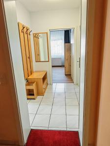 a hallway with a room with a red rug at Ferienwohnung Hoher Pön in Willingen
