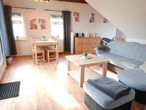 a living room with a couch and a table at Ferienwohnung Baumann in Schwarzenberg