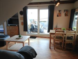a living room with a table and a dining room at Ferienwohnung Baumann in Schwarzenberg