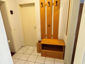 a small room with a wooden cabinet and a door at Ferienwohnung Hoher Pön in Willingen +15 photos