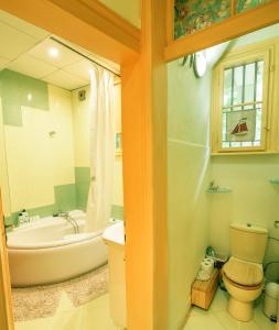 a bathroom with a tub and a toilet and a sink at TOMOVI HOME - Three bedrooms City center in Plovdiv +21 photos