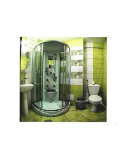 a bathroom with a shower and a toilet and a sink at Hotel VICTORY in Vama Veche