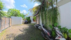 a scooter parked next to a house at Villa Manureva in Canggu