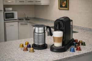 a coffee maker sitting on a kitchen counter with a cup of coffee at Vall Fosca Apartament Majue - Espectaculares vistas y jardín privado in Torre de Capdella
