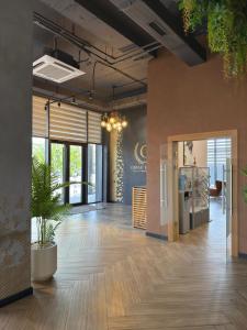 an open office with a lobby with wooden floors at Graf Hotel in Shymkent