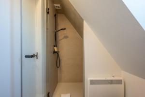 a bathroom with a staircase leading up to a attic at Calm, Light-Filled Apartment with Private Balcony in Knokke-Heist