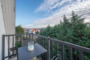 a candle on a table on a balcony at Calm, Light-Filled Apartment with Private Balcony in Knokke-Heist