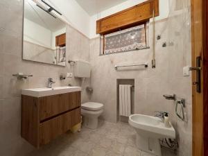 a bathroom with a sink and a toilet and a mirror at LHE Terrazza Alba in Bagno di Romagna