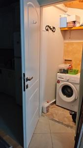 a bathroom with a washer and a washing machine at Villa Maxim in Corfu Town in Corfu