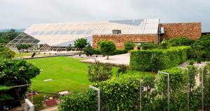 a large glass building with a garden in front of it at Mana Ranakpur in Ranakpur +91 photos