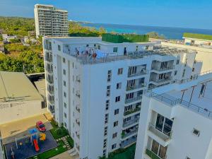 a white building with people on the top of it at Aqua seaside Apartments in Mombasa