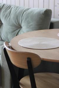 a wooden table with a plate on top of it at Красник Хілс in Krasnik