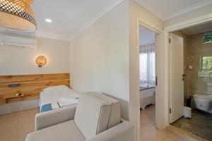 a hospital room with two beds and a bathroom at KIYI SUITES OTEL Palamutbükü in Yakaköy +31 photos