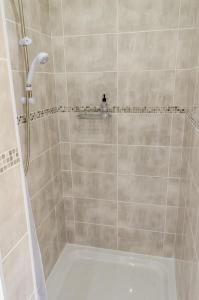 a bathroom with a shower with a tub at The Avenue in Shanklin