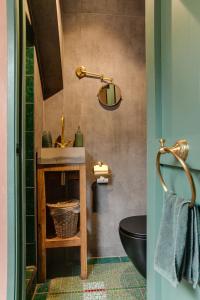 a bathroom with a sink and a toilet at BoHo Experience Wellness, Jacuzzi, Sauna, BBQ, Garden, Sleeps 10 in Kockengen +29 photos