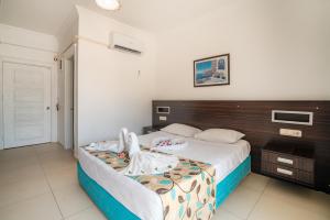 a bedroom with a bed with a wooden headboard at Side Orientt Apartments in Side +55 photos