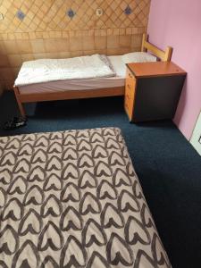 a bedroom with a bed and a dresser in it at TARAS Hostel in Belgrade