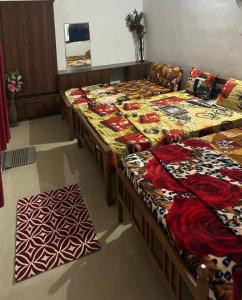 a group of beds in a large room withvariables at Matha Tourist Home , Cherupuzha in Peringom