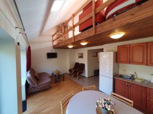 a kitchen and a living room with a table at Love Island 2 in Druskininkai