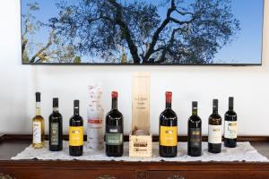 a bunch of bottles of wine sitting on a table at Podere San Michele Cantina con Camere in San Vincenzo
