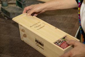 a person is opening a wooden box at Podere San Michele Cantina con Camere in San Vincenzo