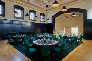 a large room with tables and chairs and lights at Malmaison Oxford in Oxford