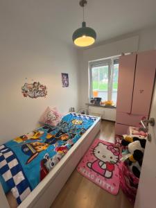 a bedroom with a bed with a hello kitty comforter at Always luxury for a luxurious life in Grimbergen