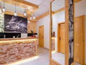 a kitchen with a brick wall and a tv at Golden Apartments - Villa Taternik - Studio with balcony in Zakopane