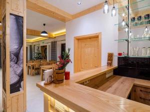 a kitchen with wooden counters and a dining room at Golden Apartments - Villa Taternik - Studio with balcony in Zakopane