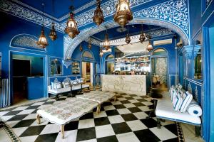a room with blue walls and a checkered floor at Hotel Narain Niwas Palace in Jaipur