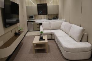 a living room with a white couch and a table at ضيافة ألسعادة للشقق ألمخدومة - قرطبة1 in Riyadh +61 photos