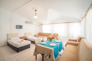 a living room with a couch and a table at Side Orientt Apartments in Side