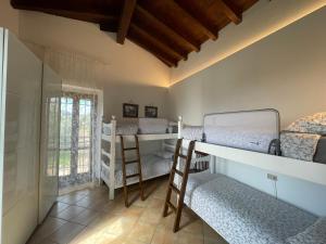 a room with two bunk beds and a window at Agriturismo Valsiniga - Your Private Family Retreat on Lake Garda Saló in Salò +61 photos