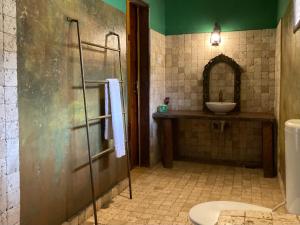 a bathroom with a shower and a sink and a toilet at KC Bungalows in Nungwi