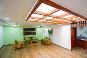 a living room with green walls and a skylight at Signature Grande with swimming pool pondicherry in Pondicherry