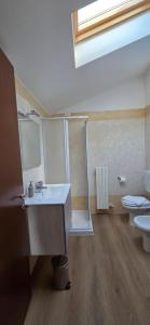 a bathroom with a sink and a toilet at Mars' apartment in Cavalcaselle +23 photos