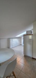an empty room with a table and a refrigerator at Mars' apartment in Cavalcaselle