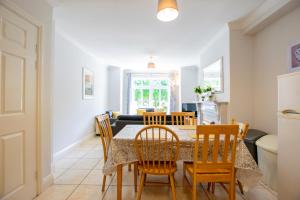 a dining room and kitchen with a table and chairs at Spacious 4-Bed Central Limerick Group Retreat in Limerick