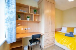 a small bedroom with a desk and a bed at Spacious 4-Bed Central Limerick Group Retreat in Limerick