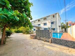 an apartment building with a swimming pool in front of it at SS Grand with swimming pool in Pondicherry