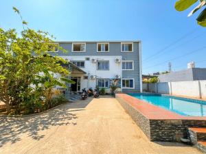 a house with a swimming pool next to a building at SS Grand with swimming pool in Pondicherry