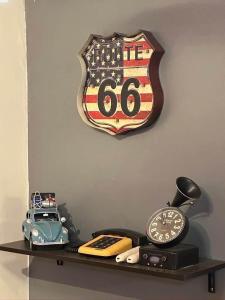 a shelf with an american flag clock and a clock at Retro Themed Condominium Staycation in Marilao
