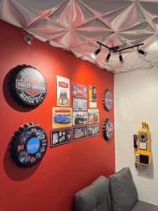 a room with a red wall with signs on it at Retro Themed Condominium Staycation in Marilao