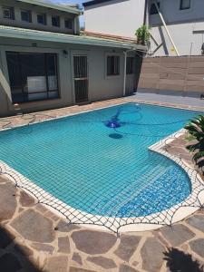 a large blue swimming pool in a yard at Peaceful Corner Stay in Durban
