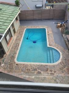 an overhead view of a swimming pool with blue water at Peaceful Corner Stay in Durban +9 photos