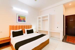 a bedroom with a large bed in a room at Hotel O Samar palace in Lucknow