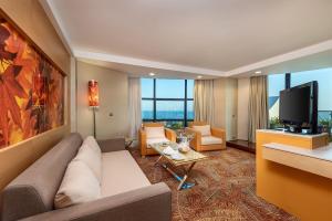 a living room with a couch and a flat screen tv at Paloma Sencia in Belek