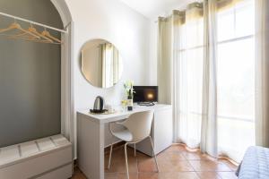 a bedroom with a desk and a mirror and a bed at Podere San Michele Cantina con Camere in San Vincenzo +39 photos